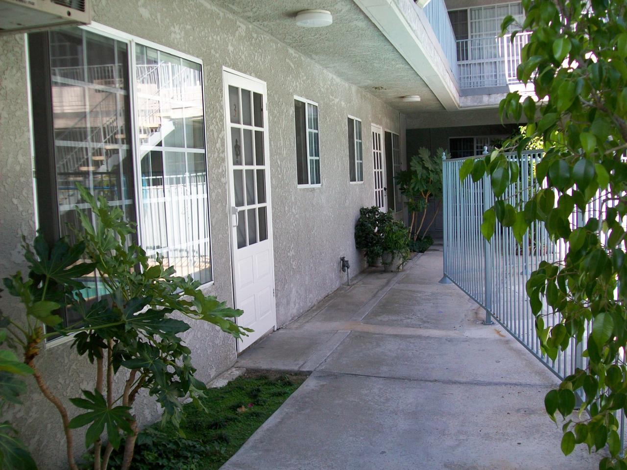 Photo of Kingsbury Villas Apartments - a view of some of the front doors of apartments